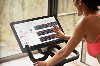 Woman on peloton stationary bike